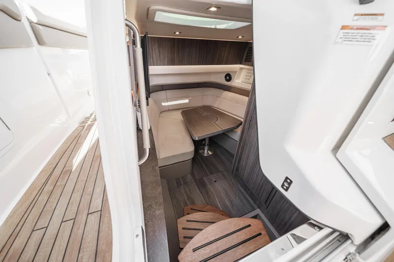 Slide: The Image of Interior of 2023 Sea Ray SLX 400 Outboard, featuring elegant seating and wooden flooring. - 27