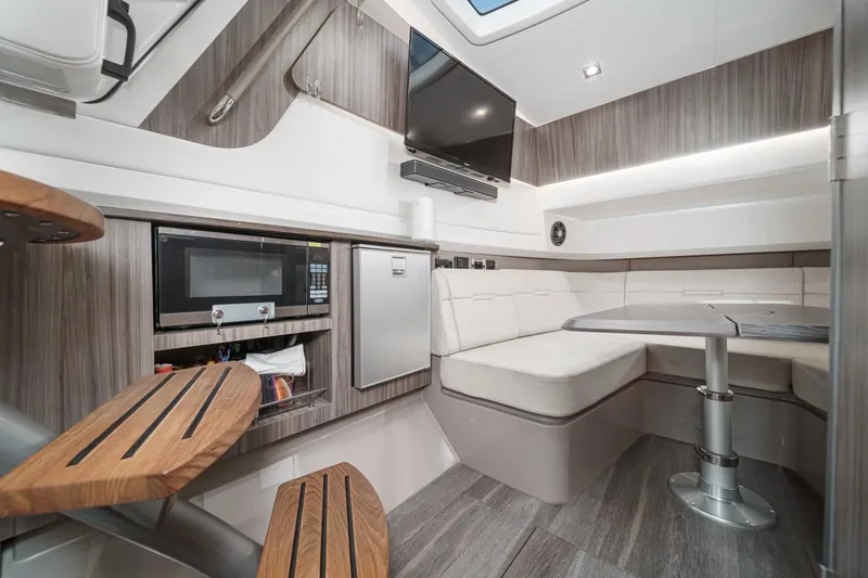 Slide: The Image of Luxurious interior of 2023 Sea Ray SLX 400 Outboard with modern amenities and seating area. - 29