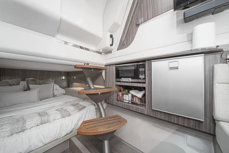 Slide: The Image of Luxurious interior of 2023 Sea Ray SLX 400 Outboard with bed, kitchenette, and modern amenities. - 30