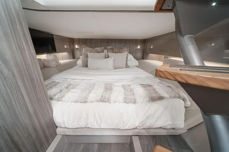 Slide: The Image of Luxurious cabin interior of 2023 Sea Ray SLX 400 Outboard with plush bedding. - 31