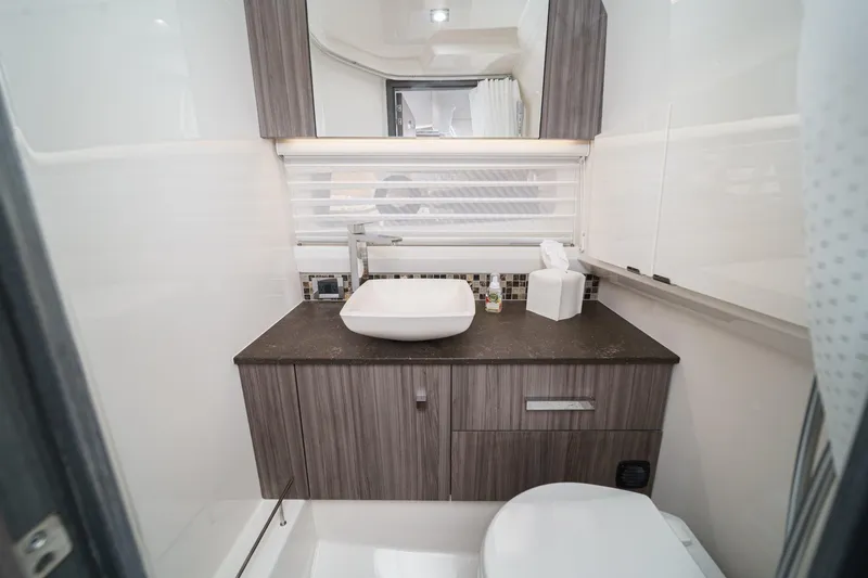 Slide: The Image of Modern bathroom interior in 2023 Sea Ray SLX 400 Outboard boat, featuring sleek design. - 33