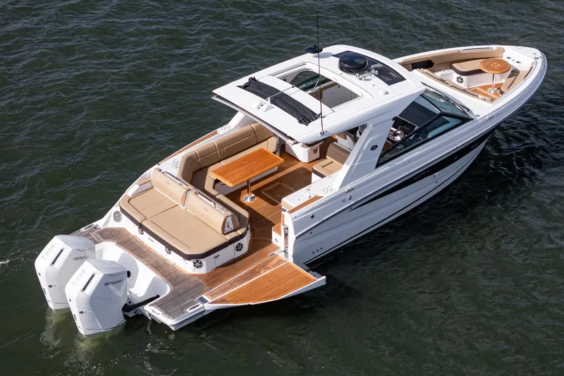Slide: The Image of 2023 Sea Ray SLX 400 Outboard luxury boat on water, featuring spacious deck and seating. - 34