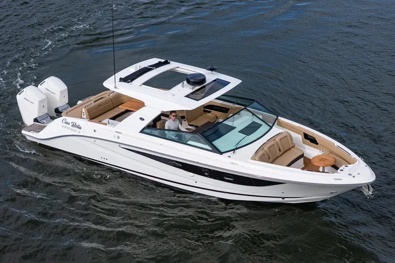 Slide: The Image of 2023 Sea Ray SLX 400 Outboard cruising on water, featuring luxurious seating and dual engines. - 38