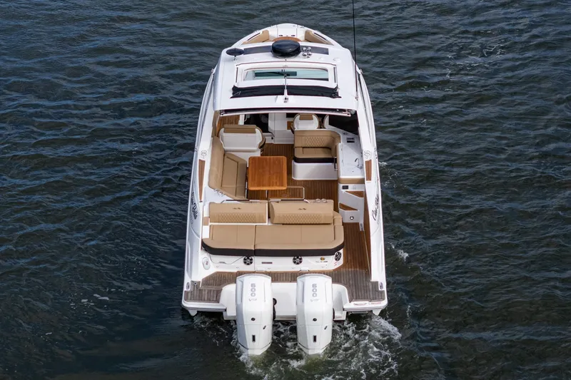 Slide: The Image of 2023 Sea Ray SLX 400 Outboard cruising on water, showcasing luxurious seating and powerful engines. - 4