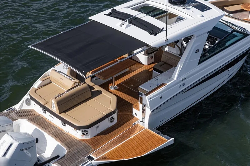 Slide: The Image of 2023 Sea Ray SLX 400 Outboard boat with spacious deck and retractable canopy. - 9