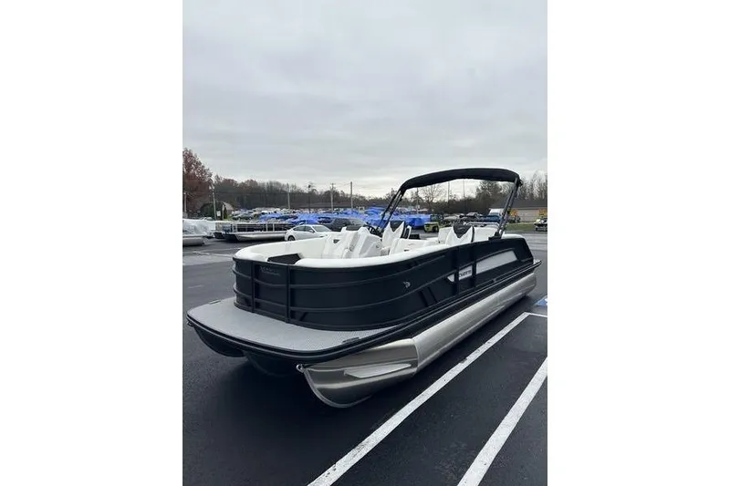 Slide: The Image of 2026 Evotti 523CS pontoon boat in parking lot, sleek black design, spacious seating. - 7