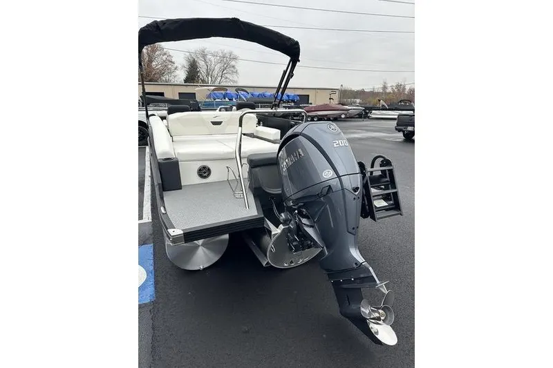 Slide: The Image of 2026 Evotti 523CS pontoon boat with Yamaha 200 outboard motor, parked outdoors. - 9