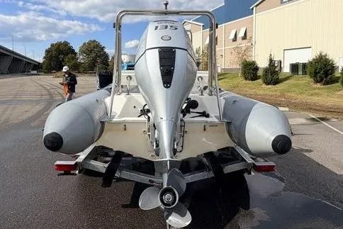 Slide: The Image of 2027 Brig Navigator 610 boat on trailer, rear view, parked outdoors. - 4