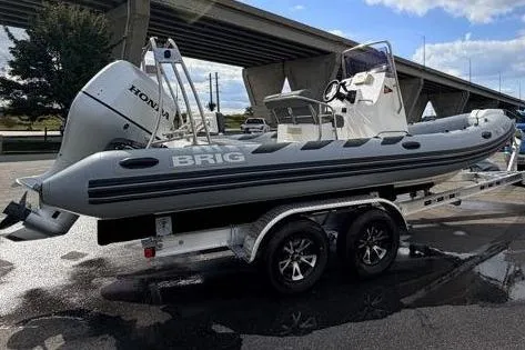 Slide: The Image of 2027 Brig Navigator 610 boat on trailer with Honda engine, parked outdoors. - 5