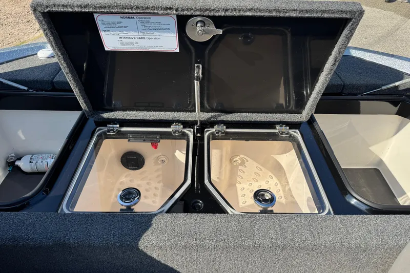 Slide: The Image of 2023 Vexus VX20 boat livewell compartments with open lids and visible interior features. - 12
