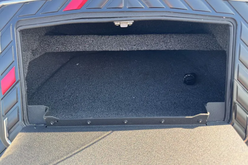 Slide: The Image of 2023 Vexus VX20 storage compartment, black interior, open lid, red accents. - 16