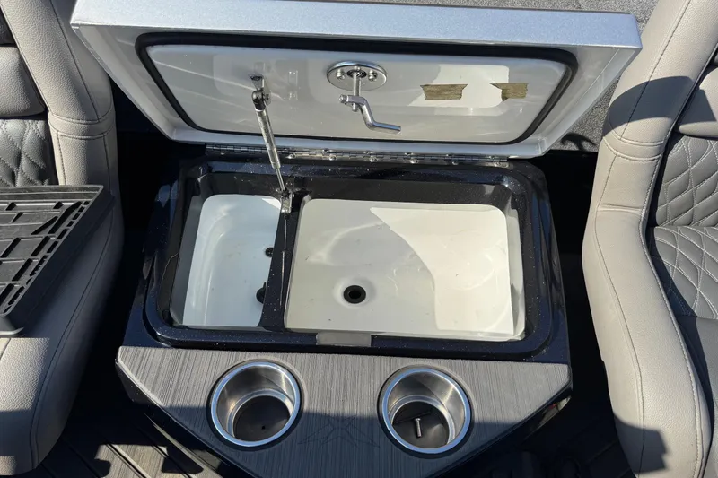 Slide: The Image of 2023 Vexus VX20 boat interior with open storage compartment and cup holders. - 20