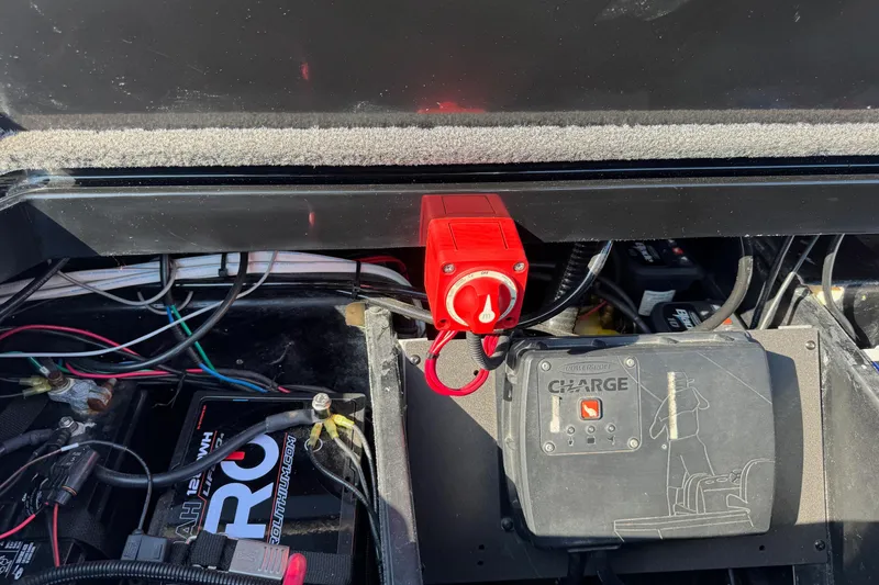 Slide: The Image of 2023 Vexus VX20 boat battery compartment with wiring and power switch. - 22
