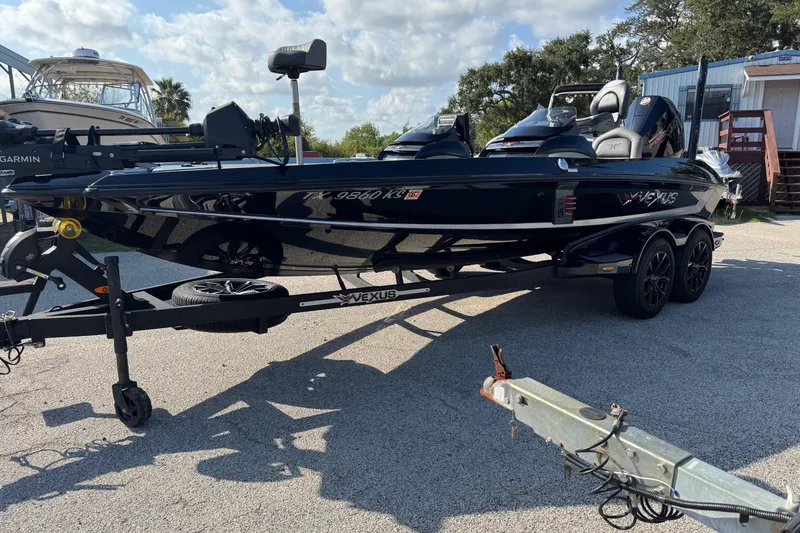Slide: The Image of 2023 Vexus VX20 boat on trailer, parked outdoors under a partly cloudy sky. - 4