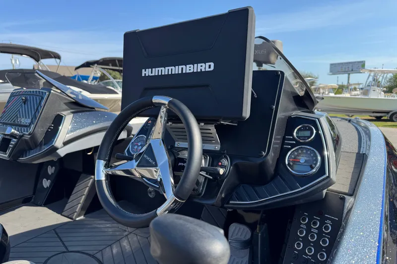 Slide: The Image of 2023 Vexus VX20 boat dashboard with Humminbird navigation system and sleek steering wheel. - 8