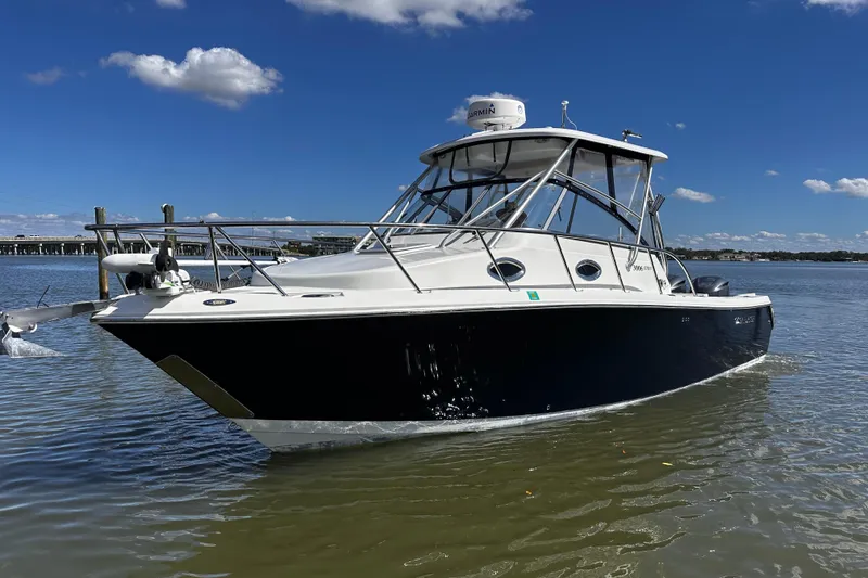 The Image of 2008 Sailfish 3006 boat on calm water under clear blue sky. - 0