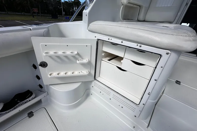 Slide: The Image of Interior storage compartments of a 2008 Sailfish 3006 boat, featuring drawers and seating. - 13