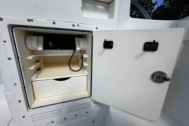 Slide: The Image of Open storage compartment on 2008 Sailfish 3006 boat with shelves and cable. - 14