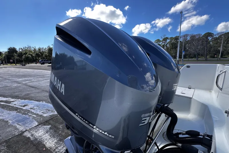 Slide: The Image of Twin Yamaha outboard motors on a 2008 Sailfish 3006 boat under a clear blue sky. - 4