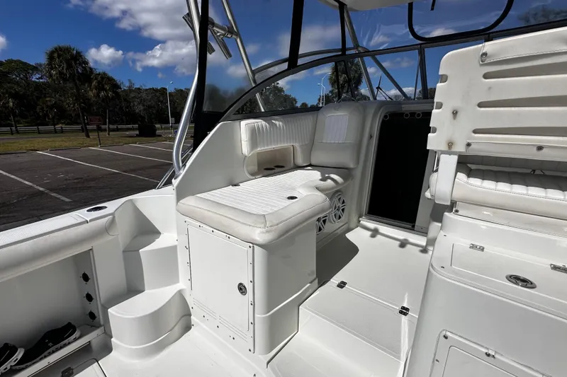 Slide: The Image of 2008 Sailfish 3006 boat interior with white seating and storage compartments. - 12