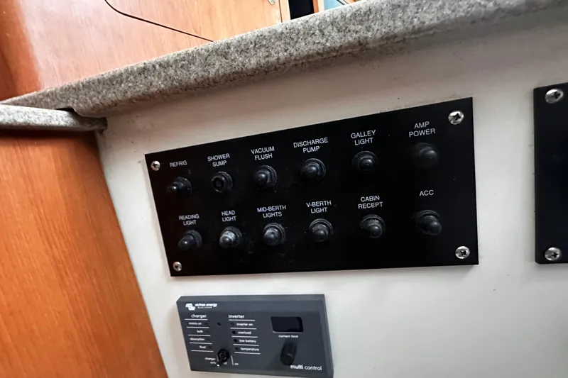 Slide: The Image of Control panel on a 2008 Sailfish 3006 boat with various switches and indicators. - 15