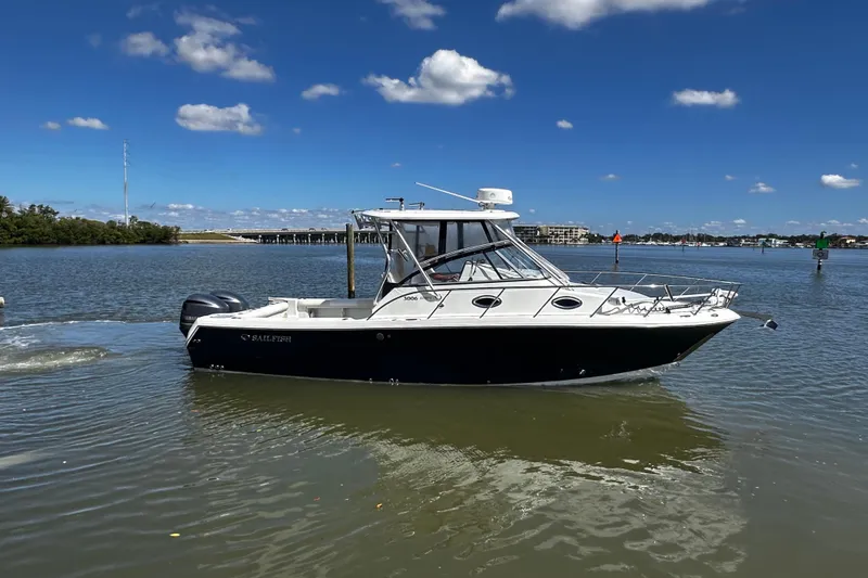 Slide: The Image of 2008 Sailfish 3006 boat on calm water under a clear blue sky. - 2