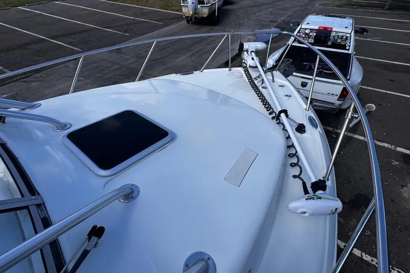 Slide: The Image of Bow view of 2008 Sailfish 3006 boat with parked truck in background. - 20