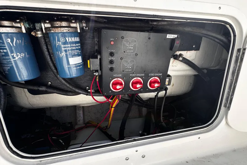 Slide: The Image of Electrical panel and fuel filters inside a 2008 Sailfish 3006 boat compartment. - 24
