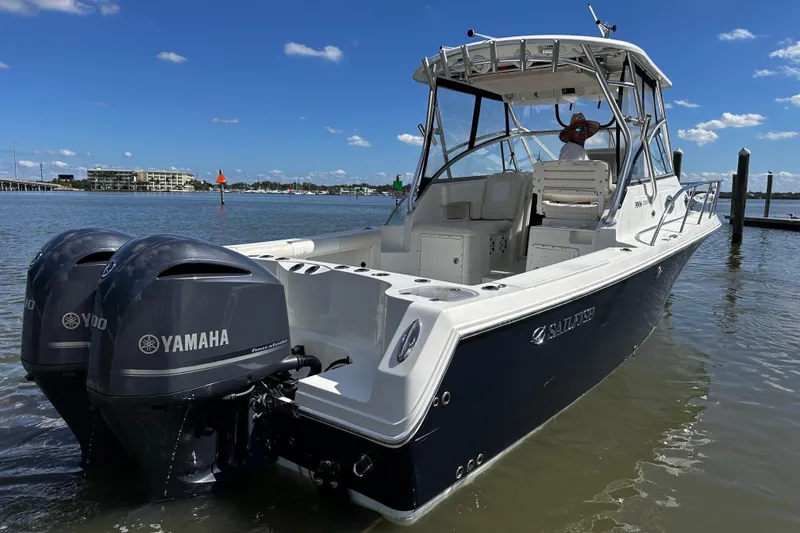 Slide: The Image of 2008 Sailfish 3006 boat with Yamaha engines docked on a sunny day. - 3