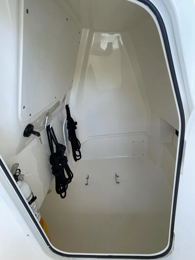 Slide: The Image of 2022 Boston Whaler 220 Dauntless boat hull in storage, side view. - 15