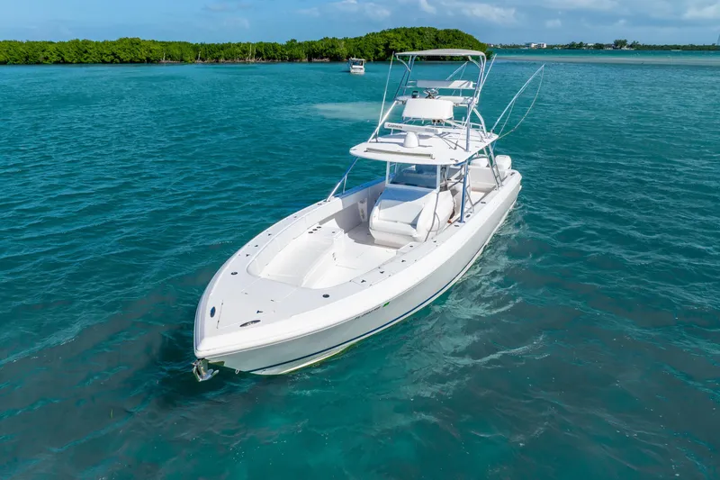 Slide: The Image of 2016 Intrepid 400 Center Console boat cruising on clear blue water. - 10