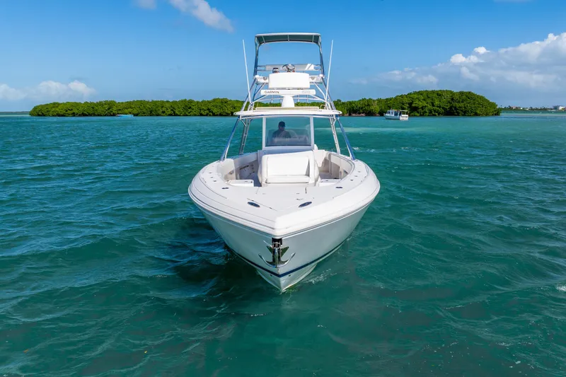 Slide: The Image of 2016 Intrepid 400 Center Console boat cruising on clear blue water. - 11