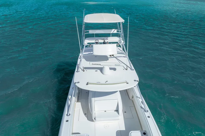 Slide: The Image of 2016 Intrepid 400 Center Console boat cruising on clear blue water. - 13