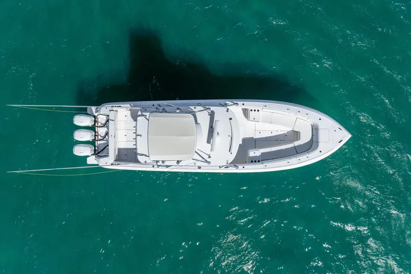 Slide: The Image of 2016 Intrepid 400 Center Console boat with triple engines on open water. - 15