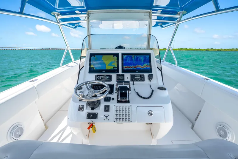 Slide: The Image of 2016 Intrepid 400 Center Console boat dashboard with navigation screens and steering wheel. - 21