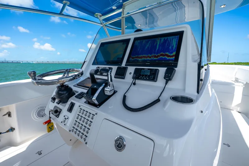 Slide: The Image of 2016 Intrepid 400 Center Console boat dashboard with navigation screens on open water. - 22
