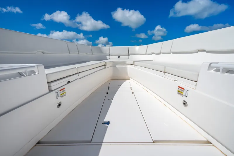 Slide: The Image of 2016 Intrepid 400 Center Console boat interior with spacious seating, under a clear blue sky. - 26