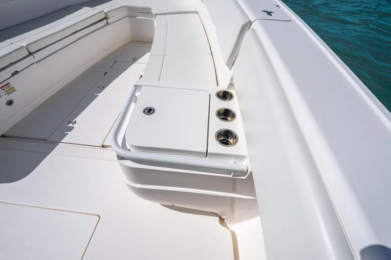 Slide: The Image of 2016 Intrepid 400 Center Console boat interior with white seating under a blue sky. - 27