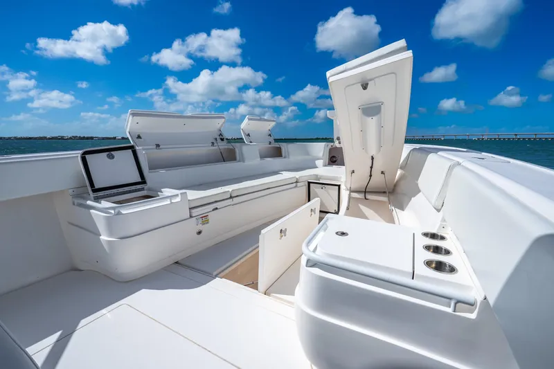 Slide: The Image of 2016 Intrepid 400 Center Console boat with open storage compartments, under a clear blue sky. - 31