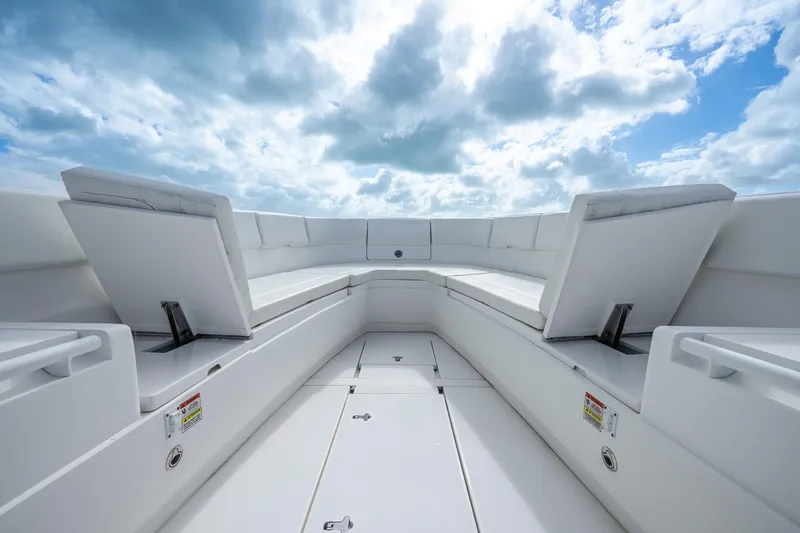 Slide: The Image of 2016 Intrepid 400 Center Console boat with open storage compartments, under a clear blue sky. - 33