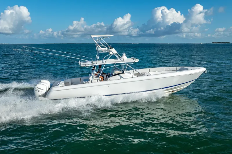 Slide: The Image of 2016 Intrepid 400 Center Console boat cruising on open water under a clear sky. - 4