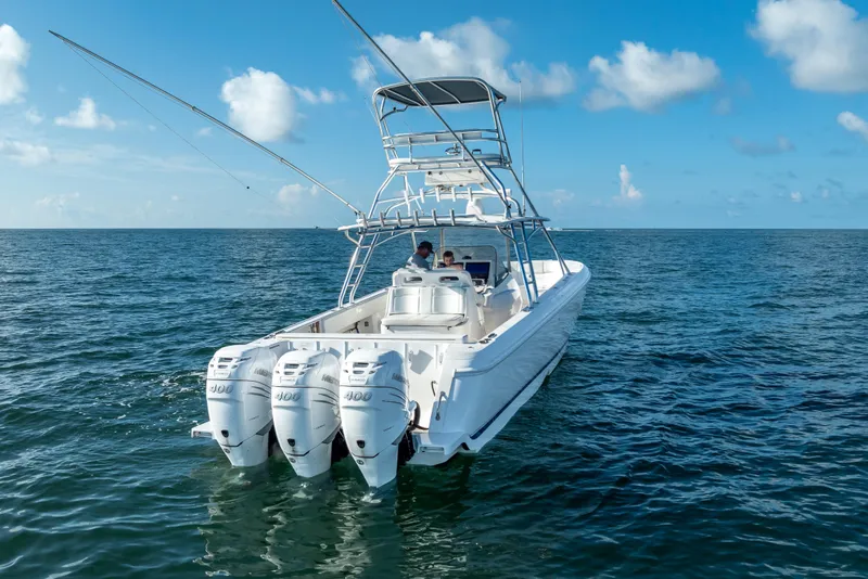 Slide: The Image of 2016 Intrepid 400 Center Console boat on open water, featuring triple outboard engines. - 59