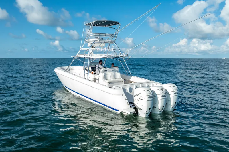 Slide: The Image of 2016 Intrepid 400 Center Console boat with triple engines on open sea. - 61
