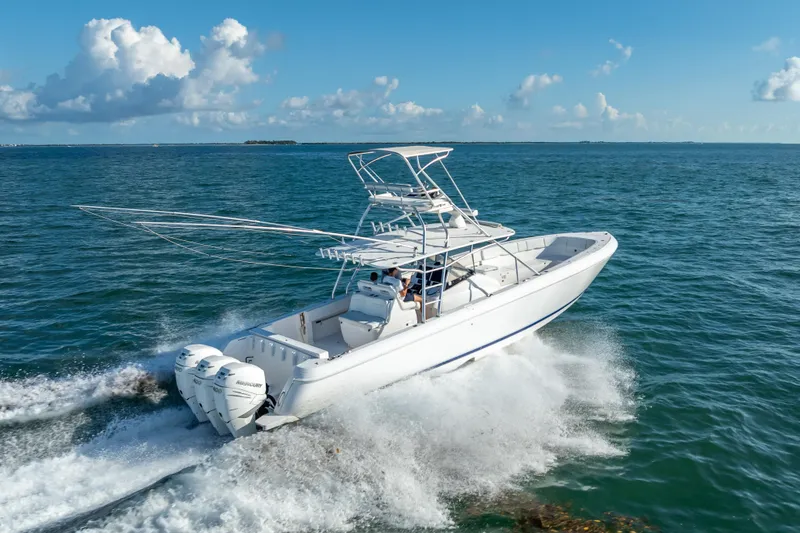 Slide: The Image of 2016 Intrepid 400 Center Console boat on open sea with triple Mercury engines. - 62