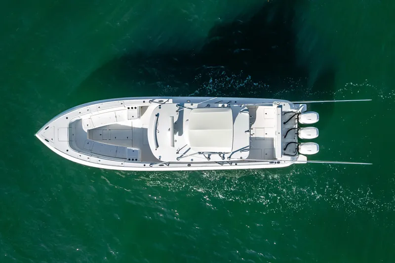 Slide: The Image of 2016 Intrepid 400 Center Console boat cruising on open water under clear skies. - 63