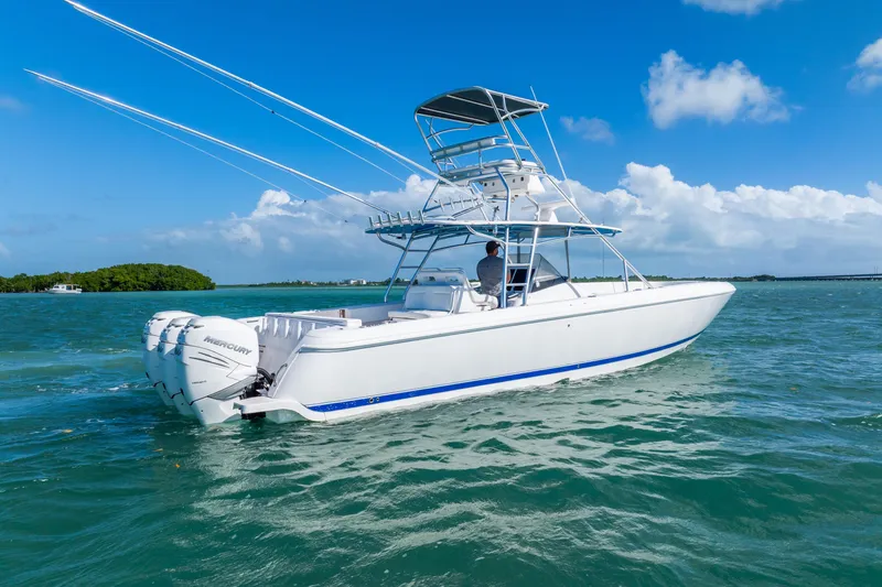 Slide: The Image of 2016 Intrepid 400 Center Console boat on clear blue water under a sunny sky. - 7