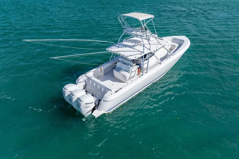Slide: The Image of 2016 Intrepid 400 Center Console boat cruising on clear blue water. - 8