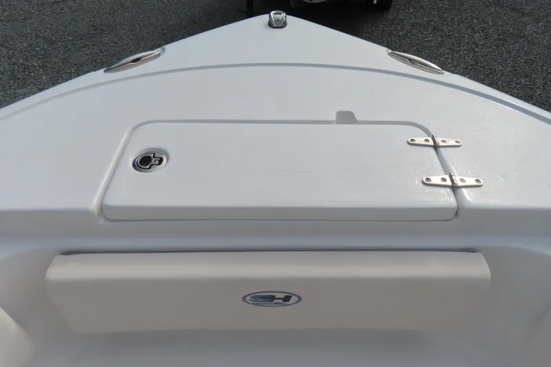 Slide: The Image of 2025 Sea Hunt Ultra 229 boat deck with storage compartment and logo. - 12