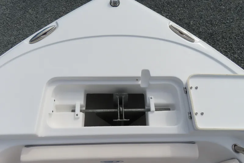 Slide: The Image of Bow anchor compartment of 2025 Sea Hunt Ultra 229 boat, featuring sleek design and storage. - 13