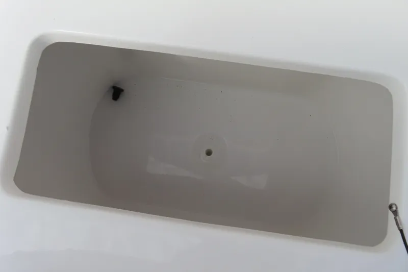 Slide: The Image of 2025 Sea Hunt Ultra 229 boat storage compartment, white interior, rectangular shape. - 18